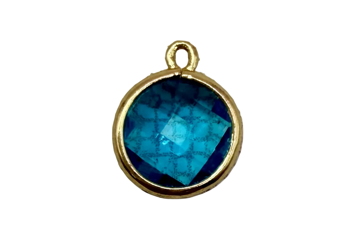 Round faceted ocean-blue gem in a polished gold frame