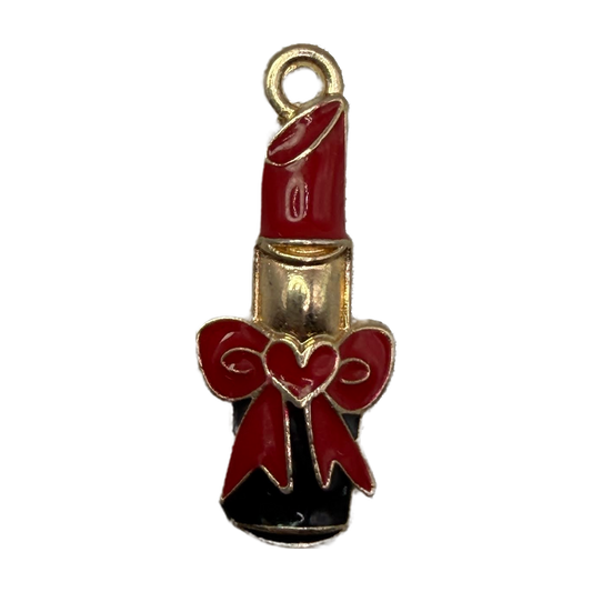 Glossy red enamel lipstick with red bow and gold outline, black base