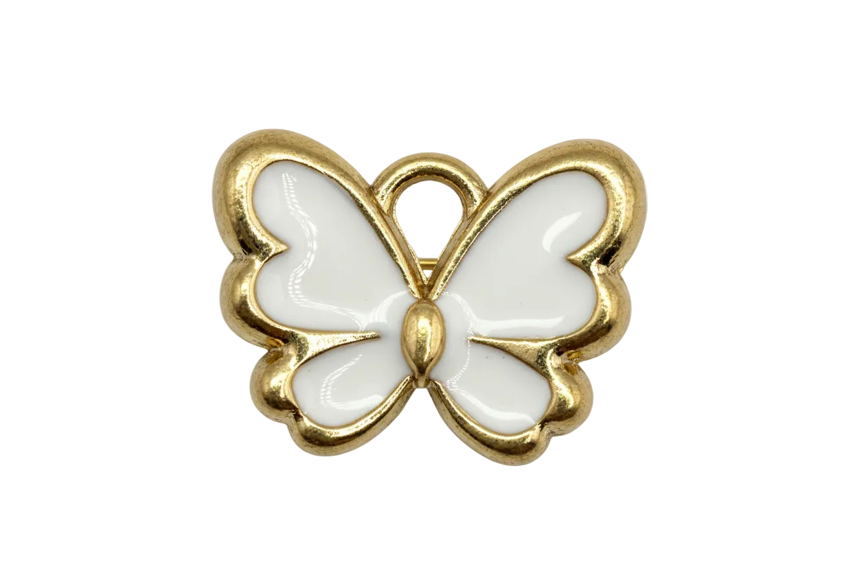 Glossy white enamel butterfly with gold outline on black background