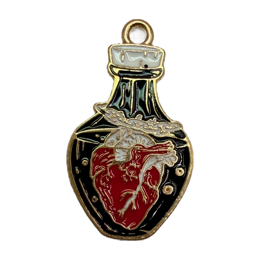 Gold-tone enamel potion bottle with black background and red anatomical heart motif