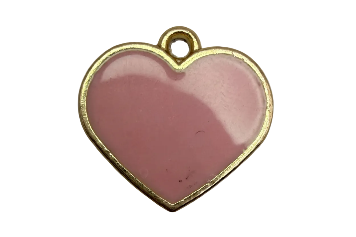 Glossy blush-pink enamel heart with gold trim on a black background