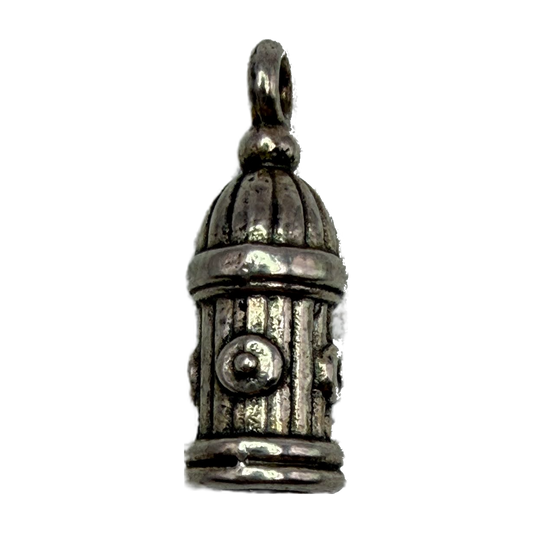 Vintage silver fire hydrant charm with oxidized patina and raised valve details on black background