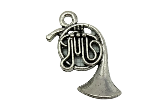 Antiqued silver French horn with coiled tubing, valve details, and a flared bell