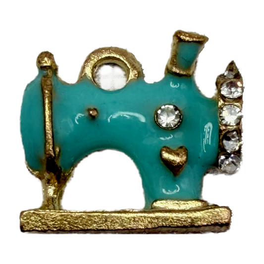 Turquoise enamel sewing machine with gold trim, heart detail, and clear crystal accents