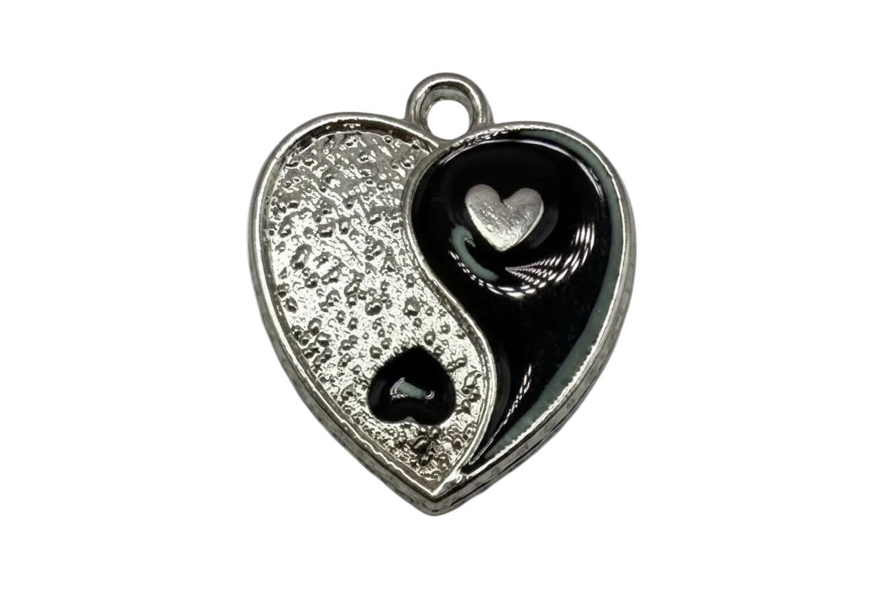 Two-tone yin-yang heart charm in silver and glossy black enamel with small heart details