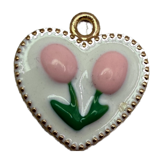 White enamel heart with pink tulips, green leaves, beaded gold edge, and small clear gem accent