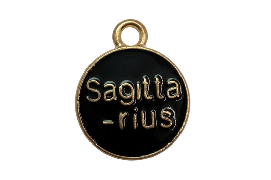 Round black enamel Sagittarius zodiac coin with raised gold lettering and gold rim