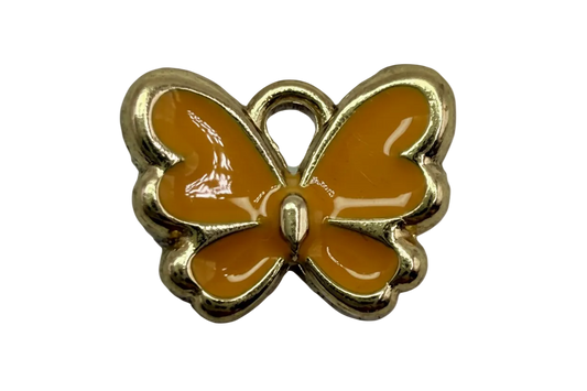Glossy orange enamel butterfly with polished gold outline on black background