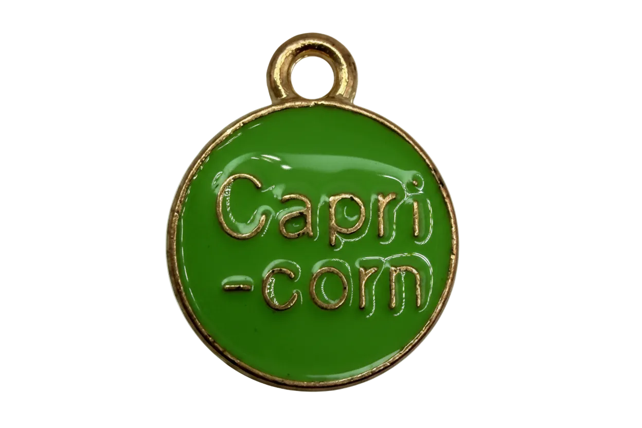 Glossy green round enamel disc with gold border and raised lettering