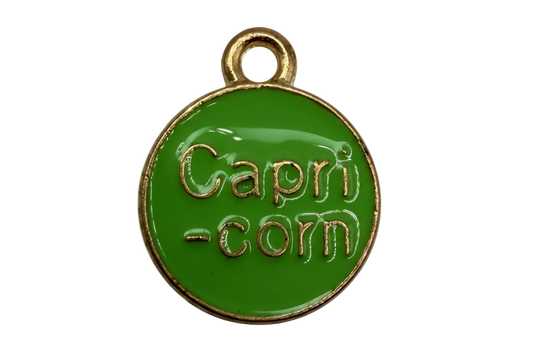 Glossy green round enamel disc with gold border and raised lettering