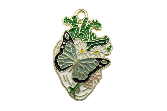 Gold enamel anatomical heart with black and teal butterfly, white daisies, and green leaves