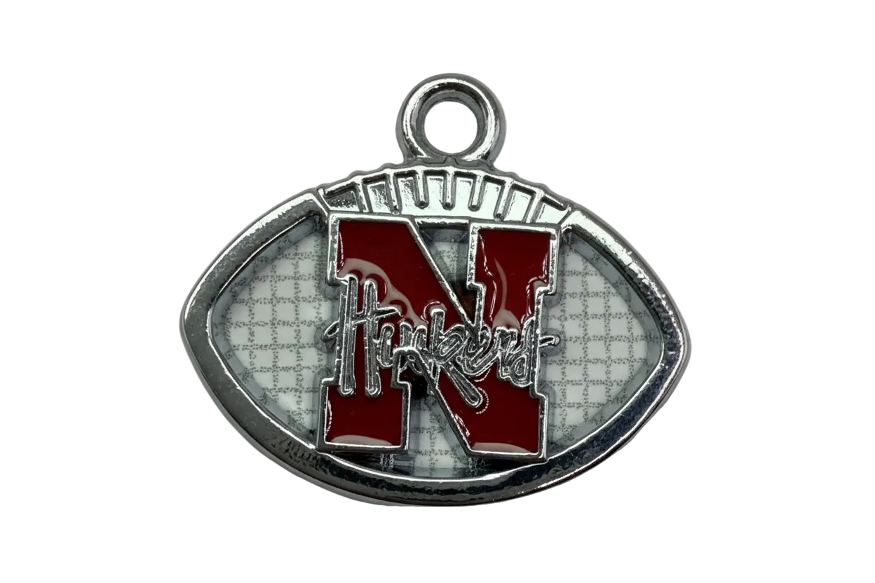 Silver football emblem with glossy red varsity letter N and white textured background