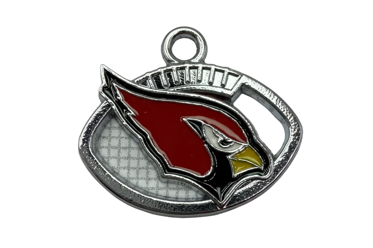 Silver-tone oval plaque with red bird head motif, black and white details, and yellow beak