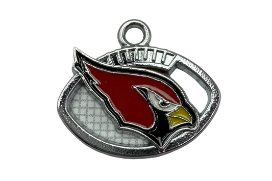 Silver-tone oval plaque with red bird head motif, black and white details, and yellow beak