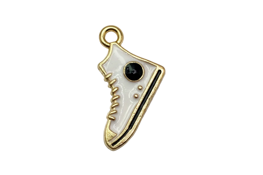 White enamel sneaker with black details and gold outline