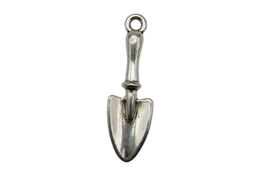 Polished silver garden trowel charm with subtle aged patina on black background