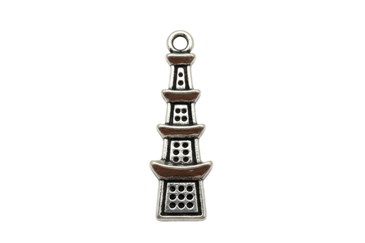 Antiqued silver pagoda tower charm with tiered roofs and cutout window details on a black background