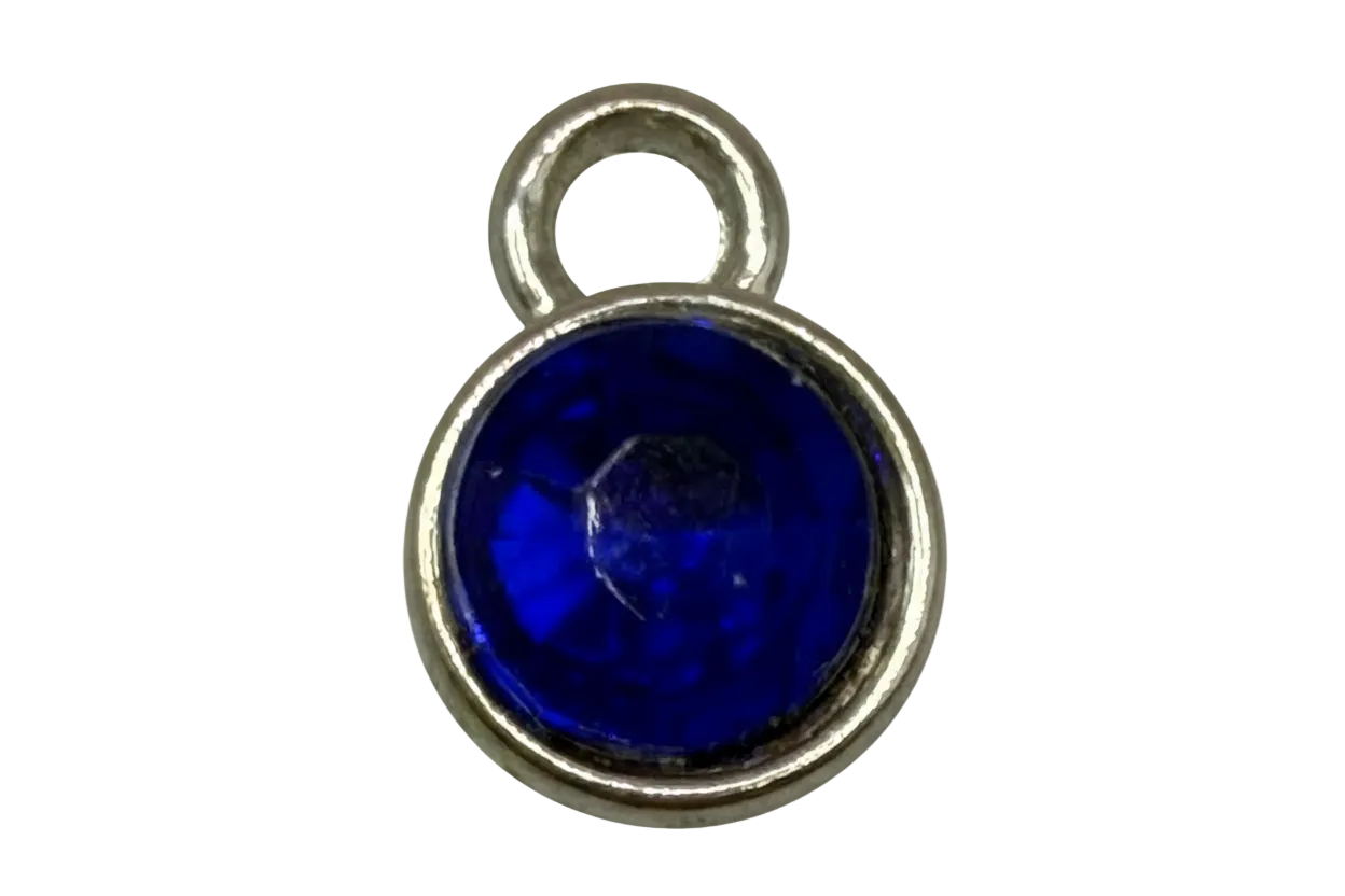 Cobalt blue round gem in polished gold frame