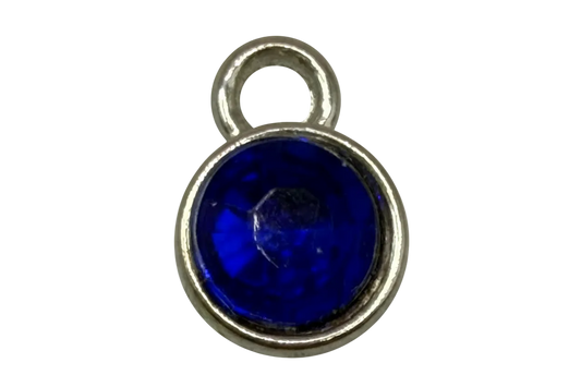 Cobalt blue round gem in polished gold frame