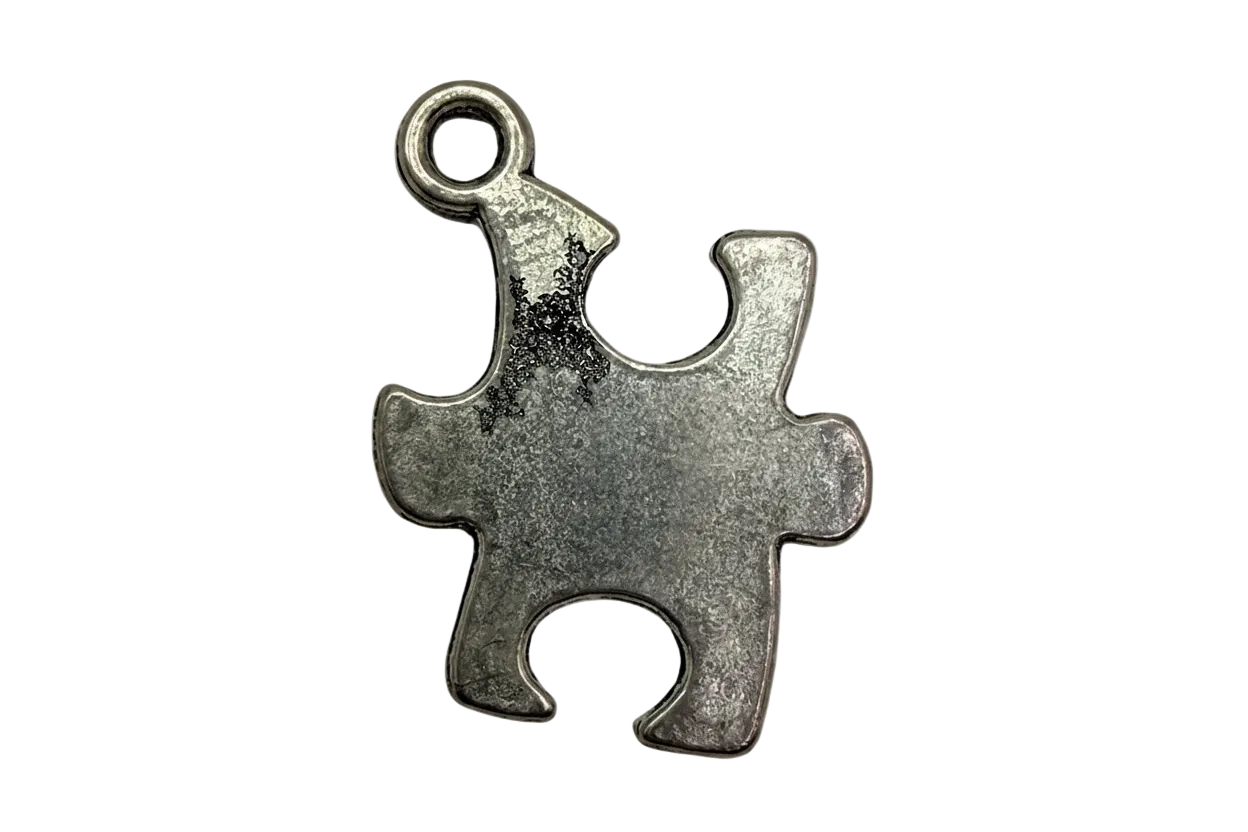 Antique silver jigsaw puzzle piece charm with brushed matte finish
