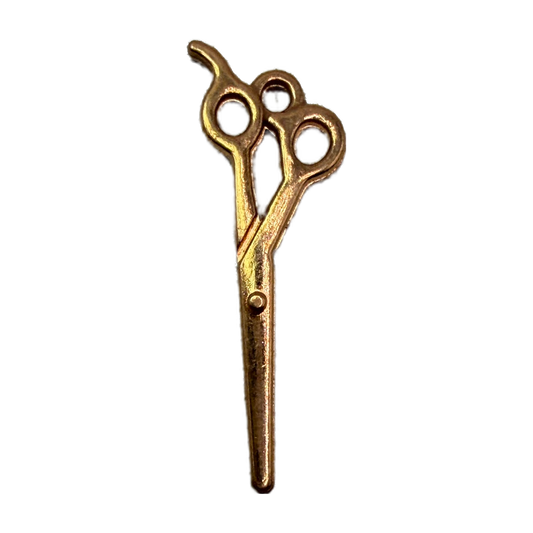 Gold scissors icon charm with vintage-style detailing on a black background