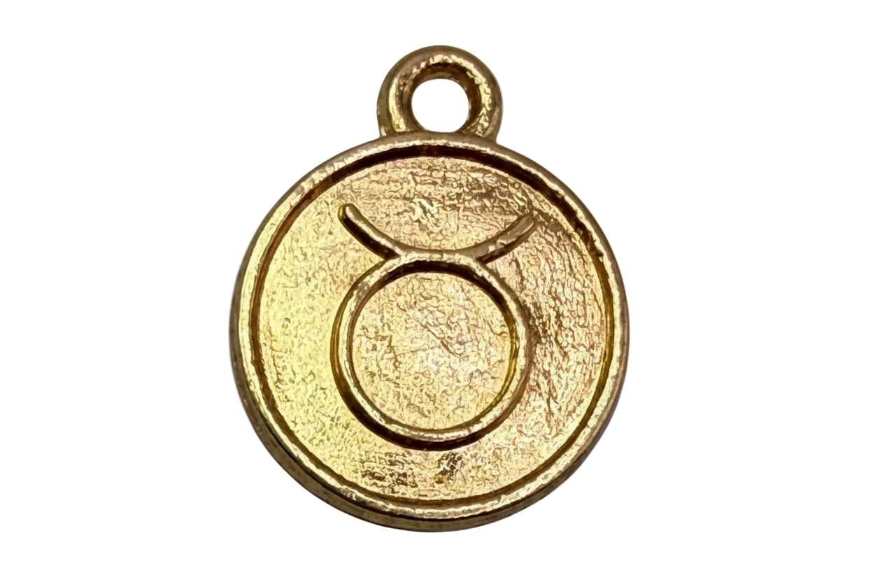 Textured gold round coin with embossed Taurus zodiac symbol