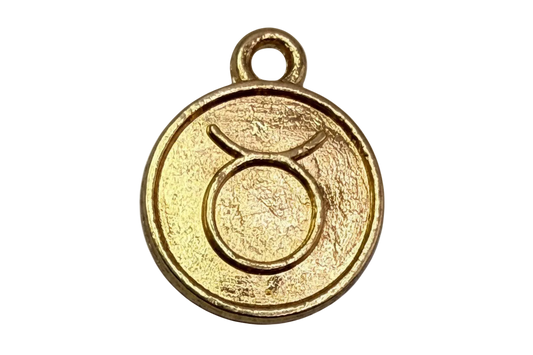 Textured gold round coin with embossed Taurus zodiac symbol