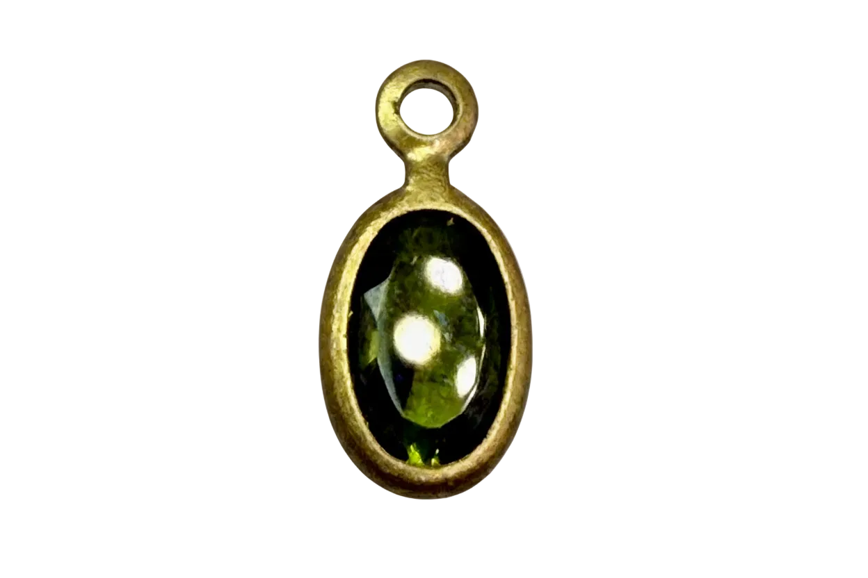 Faceted olive green oval gem framed in gold with glossy black surround