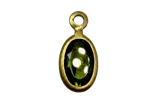 Faceted olive green oval gem framed in gold with glossy black surround