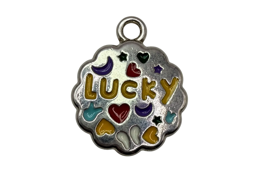 Scalloped silver medallion with gold LUCKY lettering and multicolor enamel hearts, moons, stars, and hands