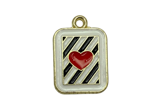 Gold framed rounded-square tile with black and gray diagonal stripes and a glossy red heart on white enamel