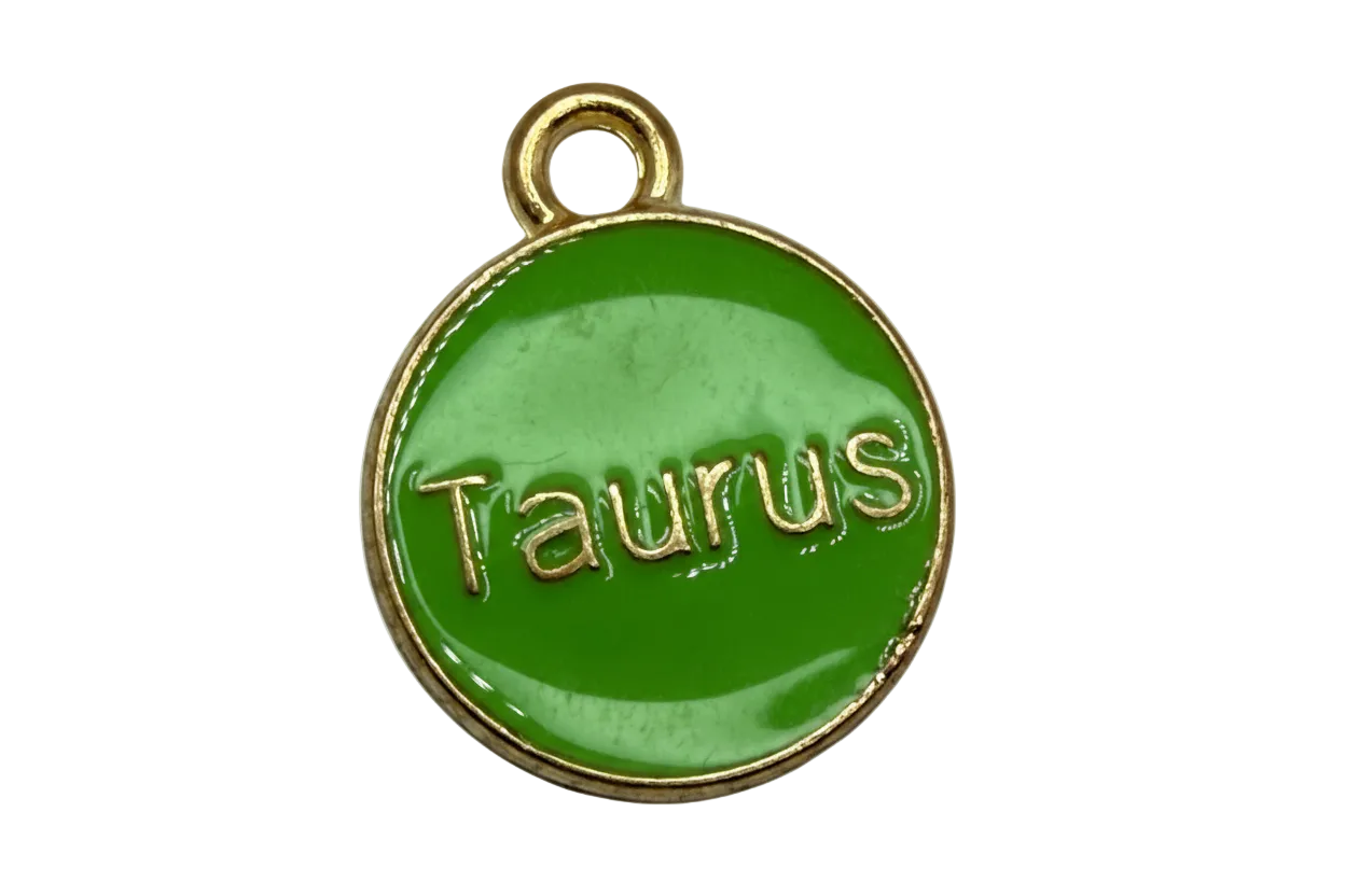 Round glossy green enamel Taurus coin with raised gold lettering