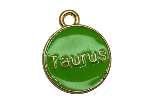 Round glossy green enamel Taurus coin with raised gold lettering