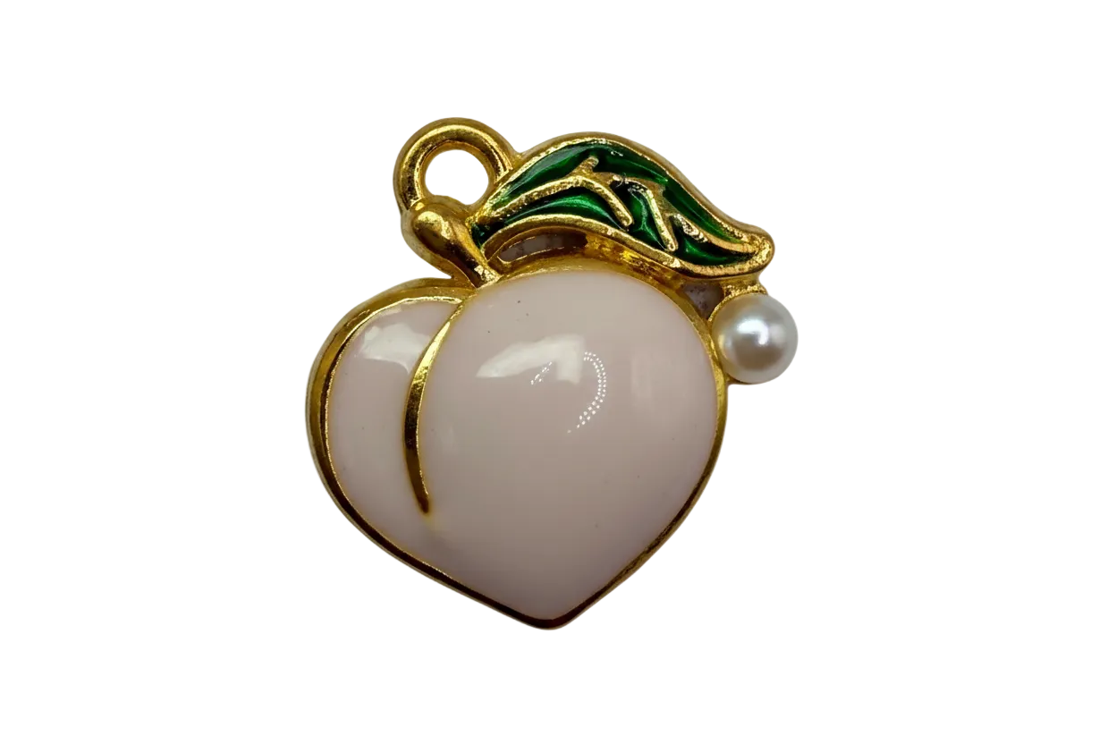 Glossy white peach fruit with gold outline and green leaf detailing