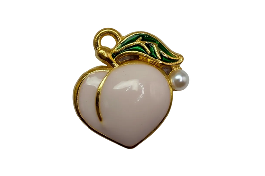Glossy white peach fruit with gold outline and green leaf detailing