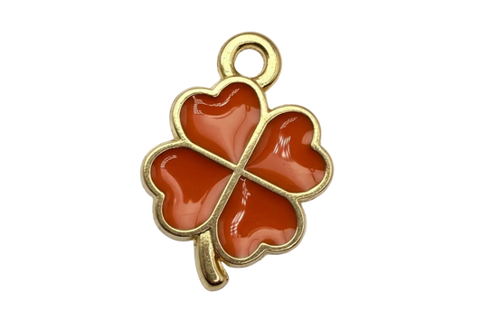 Gold four-leaf clover charm with glossy orange heart-shaped petals