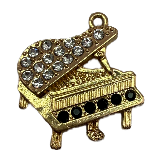 Gold grand piano charm with clear pavé crystals and black gem accents