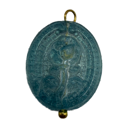 Oval teal cameo medallion with raised sacred figure relief and gold accents