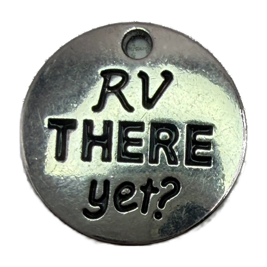 Round silver-tone disc with blackened “RV THERE yet?” lettering