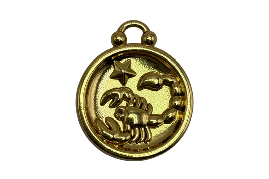 Gold medallion with raised scorpion and star motif, high-polish finish