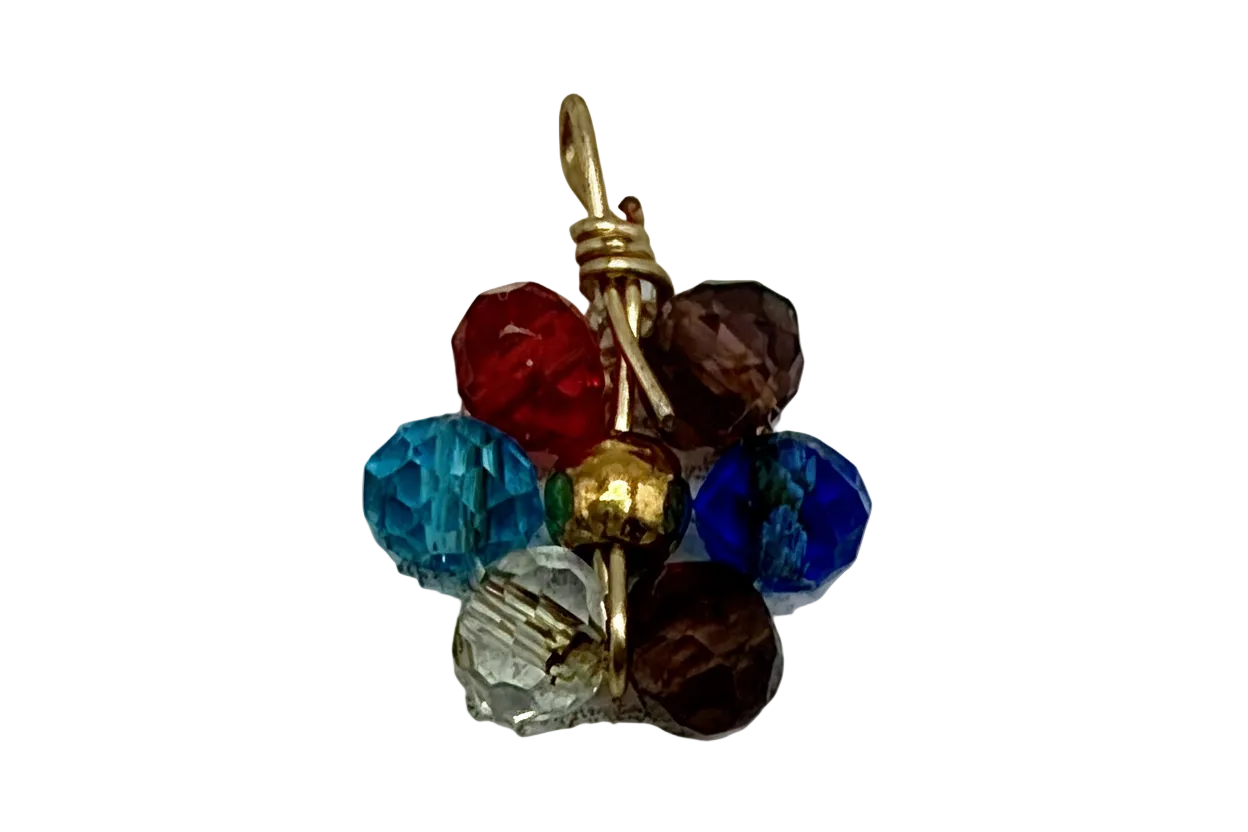 Gold metal charm with a multicolor cluster of faceted gems in blue, aqua, red, smoky brown, and clear