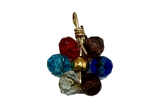 Gold metal charm with a multicolor cluster of faceted gems in blue, aqua, red, smoky brown, and clear