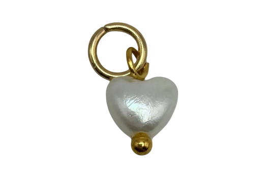 Lustrous white pearl heart charm with gold accents on black background