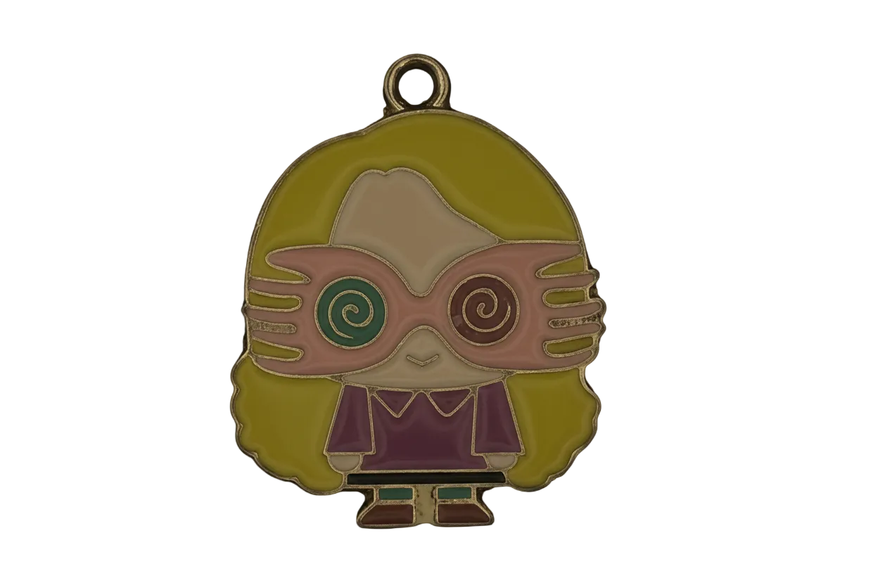 Enamel charm of a cartoon girl with spiral glasses, yellow hair, and purple clothes on a black background.