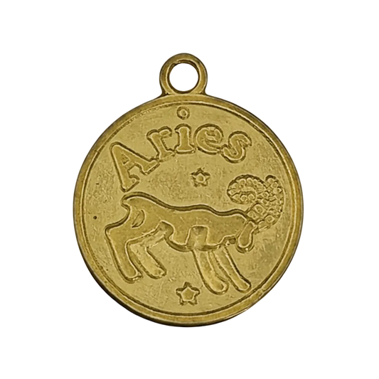 close-up of a round gold-tone Aries ram zodiac charm with stars on a black background