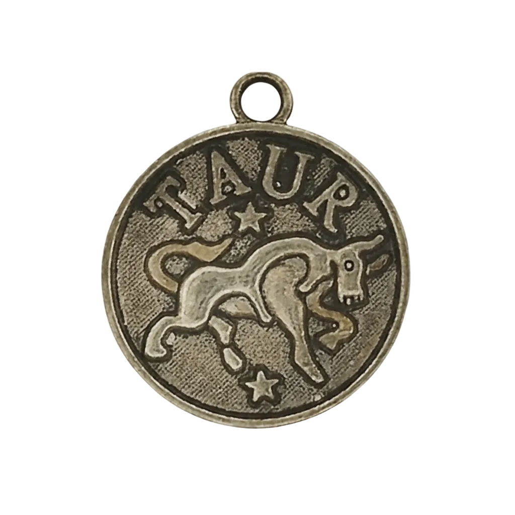 close-up of round bronze Taurus coin charm with bull and stars