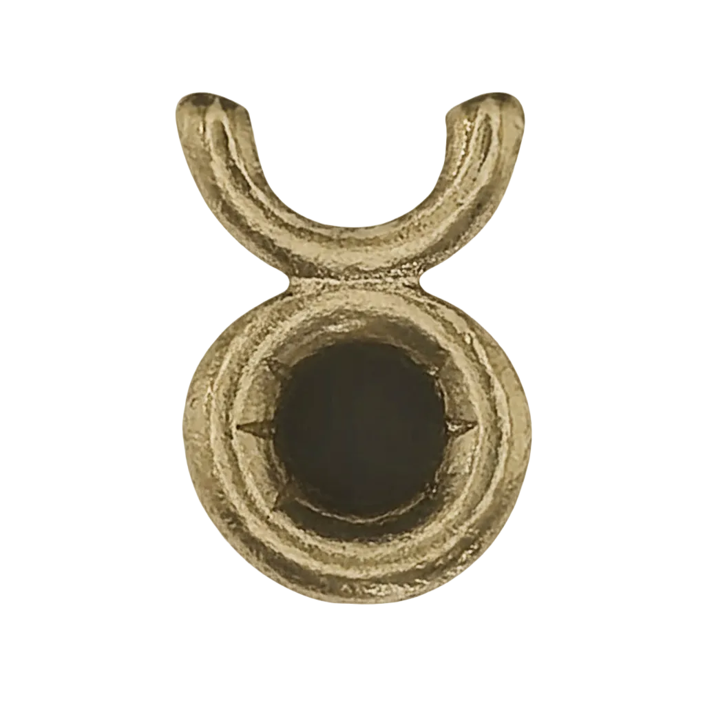 close-up of a small gold-tone Taurus symbol charm on a black background