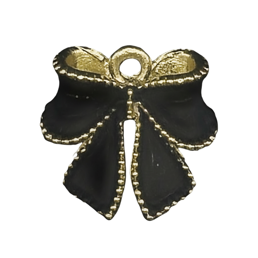 close-up of a black bow charm with gold edging on a black background