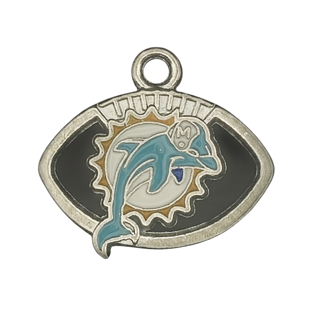 close-up of enamel dolphin charm in a football-shaped frame, silver and teal on black background