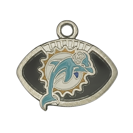 close-up of enamel dolphin charm in a football-shaped frame, silver and teal on black background